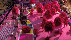 a model train set is shown with trees and other decorations