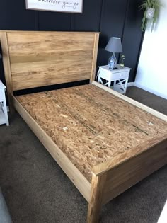 a wooden bed frame with no headboard and foot board