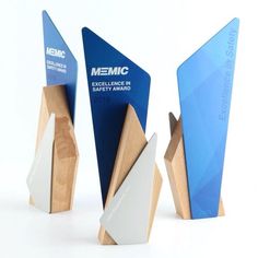 three wooden awards with blue and white designs