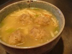 a bowl filled with meatballs and noodles