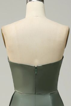 a mannequin with a green dress on it's back and zippers