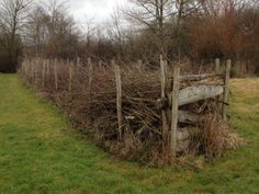 an old wooden fence in the middle of a field