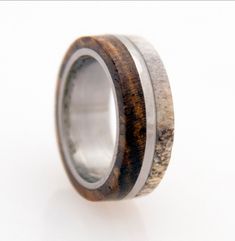 a wooden ring with antler and silver inlays