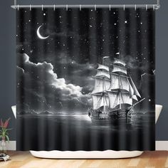 a black and white shower curtain with a ship floating in the ocean at night time