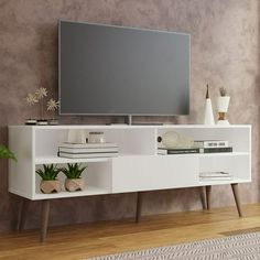 an entertainment center with a flat screen tv mounted on it's side, in a living room