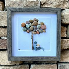 a tree made out of rocks in a frame