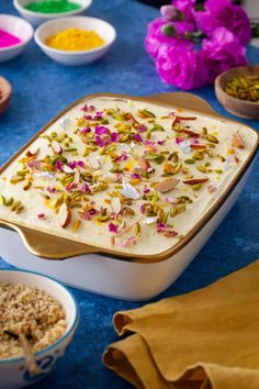 the food is ready to be eaten on the table with other bowls and spoons