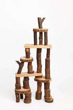 a cat tree made out of logs on a white background