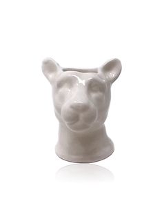 a white ceramic animal head on a white background