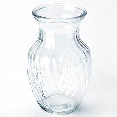 a clear glass vase sitting on top of a white table