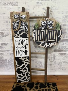 two wooden signs with the words home sweet home and a leopard print design on them