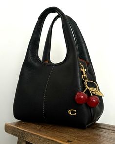 Coach lana 23 bag and cherry charm Stile Casual Chic, Luxury Bags Collection, Handbag Essentials, Girly Bags, Elegante Casual, Red Cherry, Fancy Bags, Pretty Bags, Cute Bags