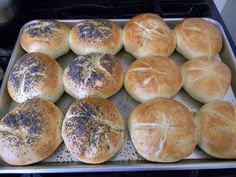 freshly baked bread rolls sitting on a baking sheet in the oven, ready to go into the oven