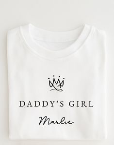 Get your little ones ready for fathers day with this personalised children's T-shirt from Mini Royals . The pullover t-shirt features a pink or white tshirt with the text daddy's girl.  You can personalise the sweatshirt by adding your child's name, just make sure to double check the spelling as personalised items are non-refundable. This unisex kids' t-shirt is a great addition to any child's wardrobe and is perfect for cooler days. Order now and make your child's birthday extra special! 100% C Girls Top, Father's Day T Shirts, North Wales, Girl T Shirt, Kids Tops, Girl Top, Kid Names, White Tshirt, Girls Tshirts