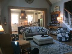 a living room filled with furniture and a clock on the wall