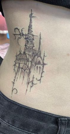 a woman with a tattoo on her stomach has a castle in the middle of it