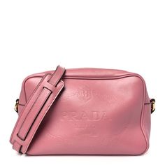 This is an authentic PRADA Glace Calfskin Embossed Logo Crossbody in Loto. This chic cross-body camera case style bag is crafted of Prada signature textured calfskin leather in pink. The bag features a cross-body strap with a gold buckle and gold hardware. The top zippers open to a black Prada monogram interior. Prada Cleo Bag Pink, Body Camera, Camera Case, Embossed Logo, Emboss, Gold Hardware, Cross Body, Calf Skin, Prada