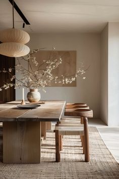 a dining room table and chairs in front of a painting