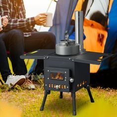 two people sitting next to each other in front of a stove with a cup on it