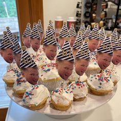 many cupcakes with faces and hats on them are arranged in the shape of men's heads