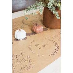 two small pumpkins sitting on top of a table