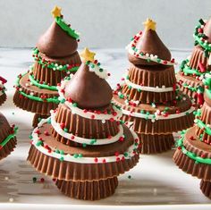 chocolate christmas trees are arranged on a tray with sprinkles and candy canets