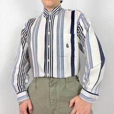 Vintage Nautica shirt in white with funky striped pattern. Cotton button up, has long sleeves & single chest pocket featuring embroidered logo. Great condition, labelled size medium or suits smaller oversized, measurements below Length: 32 inches Pit to pit: 23 inches £3 UK P&P 💌 Model is 5'9 and a men's medium Please get in touch for more measurements All items are second-hand so please expect small signs of wear - any major flaws will be noted White Button-up Shirt With Contrast Stripes, Preppy Grunge, Vintage Button-up Shirt With Striped Collar, Shirt Pattern, Stripes Pattern, Casual Tops, Top Shirt, Shirts Tops, Tee Shirts