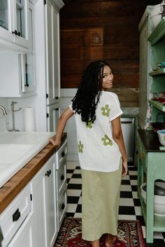 Elevate your style with our Green Flower Crochet Top! Featuring a scoop neckline and short sleeves, this top is not only fashionable, but also comfortable with its stretchy and lightweight design. The crochet details and loose fit add a touch of bohemian charm. Perfect for any occasion, this cream top with green flowers will surely turn heads. runs true to size with stretch model, Kennedi is wearing a size small Flower Crochet Top, High Waisted Midi Skirt, Boutique Trends, Skirts Midi High Waisted, Cream Top, Flower Crochet, Green Flower, Crochet Details, Romper Dress