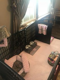 a baby's crib in the corner of a room with several items on it