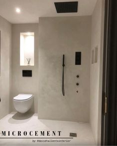 a bathroom with a toilet, sink and shower in the middle of it's walls