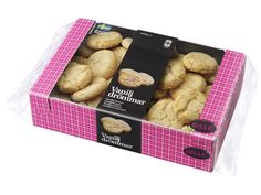 a pink box filled with cookies on top of a table