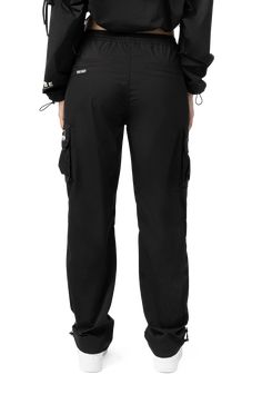 Details Fit: Jayden Slouched, Straight Stretchy Polyester Fabric Color Coated Metal Eyelets Utility Slouch Straight Polyester Pants Cargo Pockets With Screen Print Details Adjustable Bungee Detail At Leg Opening Color: Black Material: 98% Polyester / 2% Elastane Style: EP24171EC Black High-waisted Cargo Pants With Drawstring, Black Cargo Pants With Elastic Waistband, New York Streetwear, Pants Cargo, Polyester Pants, Straight Pants, Screen Print, Everyday Outfits, Fabric Color