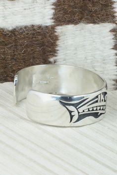 This sterling silver bracelet was made by Hopi silversmith Timothy Mowa. The inside is signed and stamped sterling.Size: 5 3/4" (will fit up to a 6 1/4" wrist)Gap: 3/4"Width: 3/4"Free shipping on all orders! We ship with USPS and always include tracking. All orders ship within a day of payment.Returns are accepted up to 30 days after you receive your order. Just send us a message. Our shop offers cash back or store credit. The item must be returned in new condition. Unique Stamped 925 Bracelet Jewelry, Unique Stamped Jewelry For Formal Occasions, Unique Jewelry Bracelet, Unique Engraved Sterling Silver Bracelet For Formal Occasions, Southwestern Sterling Silver Bracelet Stamped 925 As Gift, Etched Sterling Silver Round Bracelets, Artisan Adjustable Bracelets Stamped 925, Sterling Silver Stamped Bracelet, Unique Etched Sterling Silver Adjustable Bracelet