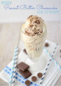 an ice cream sundae with chocolate chunks and whipped cream on the top is sitting on a white plate