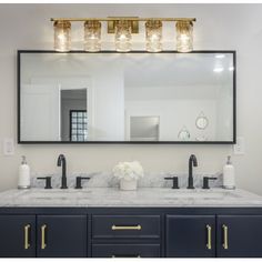 a bathroom vanity with two sinks and a large mirror above it, in front of a walk - in shower