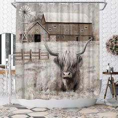 a shower curtain with an image of a long haired cow in a field next to a barn