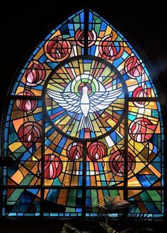 a large stained glass window with a bird on it