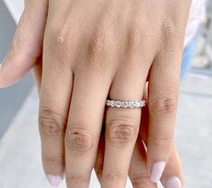 a woman's hand with a diamond ring on it