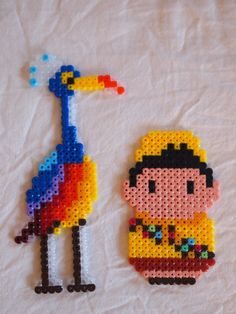 two pieces of beaded art on a white surface with one being a bird and the other is a giraffe