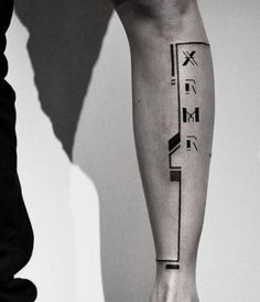 a person with a black and white tattoo on their arm is standing next to another person's leg