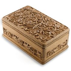 an intricately carved wooden box on a white background