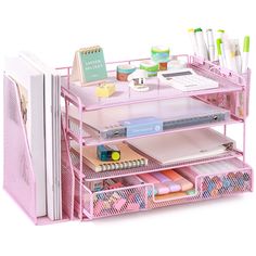 a pink desk organizer with pens, notebooks and other office supplies