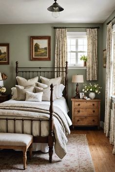 a bedroom with green walls and white bedding, wooden furniture and paintings on the wall