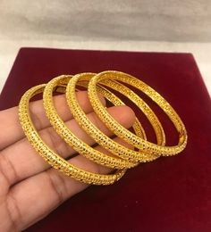 Christmas Gift, Holiday Gift,  24k gold plated Bangles, Indian Bridal Bangles, Handmade Bracelet for Women Gold Bangles for Women - Indian Bridal Bangles - Handmade Bracelet These stylish bangles feature a classic bangle design and are available in gold color. ▶ BEAUTIFUL HINGED GOLD BRACELET ▶ HIGED TO OPEN WIDE----- STAYS SECURELY SHUT -----  LIFT TAB SIDE TO OPEN Material: High quality 24k gold plated bangles ( Not solid gold) Diameter: 2.36 inches Can open Lead & Nickel free Tarnish resistan Gold Round Jewelry For Puja, Round Gold Jewelry For Puja, Gold Openable Round Bangle, 22k Gold Round Bangle, Gold Plated Bangle For Puja, Yellow Gold Plated Bangle For Puja, Openable 22k Gold Bangle, Gold-plated Gold Bracelets For Puja, Gold Bangle With Tilla For Festivals