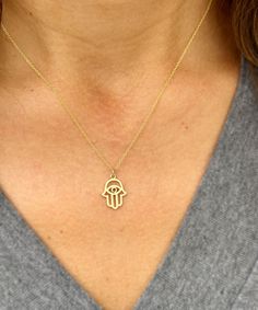 Embrace elegance and meaningful symbolism with this Hamsa style pendant and chain, crafted in 14k solid yellow gold.  This minimalist necklace features a beautifully designed Hamsa charm, symbolizing protection, luck, and good fortune. Perfect for weddings, bridal gifts, or anniversaries, this necklace combines timeless beauty with heartfelt sentiment.  The delicate and dainty design ensures it complements any outfit, adding a touch of sophistication and grace. Presented in an elegant gift box, Spiritual 14k Gold Charm Necklaces, 14k White Gold Charm Necklace With Adjustable Chain, Spiritual 14k Gold-filled Yellow Gold Charm Necklace, Spiritual 14k Gold Filled Yellow Gold Charm Necklaces, 14k Gold Symbolic Charm Necklace With Round Pendant, Symbolic 14k Gold Necklaces, Spiritual 14k Gold Charm Necklaces With Adjustable Chain, Spiritual Yellow Gold Charm Necklaces For Wedding, Spiritual 14k Gold Charm Necklace With Adjustable Chain