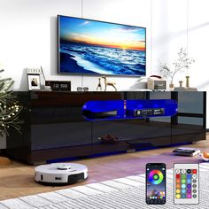 a living room with a television and remotes on the floor in front of it