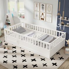 a white crib with black crosses on the floor