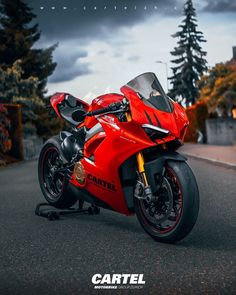 a red motorcycle is parked on the street