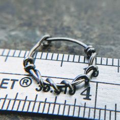 I carefully handform these simple hoops out of 22 gauge (0.644mm) sterling silver, niobium or gold fill wire and file the ends then twist a tendril of wire around the hoop for a touch of pretty. Shown: Shots 1&2: 22g niobium/rose gold fill 6mm id Shot 3-8: 22g niobium/niobium 10mm id Shot 9: 20g niobium/gold fill 10mm id The final shot shows the 28g 14k white, 26g 14k yellow, 24g 14k pink, 22g niobium and 20g sterling silver so that you can compare colors and thickness. Listing is for one (1 Unique Nose Rings, Earring Cartilage, Golden Copper, Helix Hoop, Extreme Metal, Cartilage Hoop, Lip Ring, Metal Chain Link, Cartilage Earrings