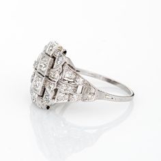 Elegant & finely detailed Art Deco era ring (circa 1920s to 1930s), crafted in 900 platinum.   Two centrally mounted estimated 0.20 carat (each) Old European cut diamonds are accented with an estimated 0.34 carats of single cut diamonds. The total diamond weight is estimated at 0.74 carats (estimated at I-J colour and VS2-SI1 clarity).     The ring epitomises vintage charm and would make a lovely alternative engagement ring. The stylized square mount reflects the clean lines and geometric forms Classic Platinum Cluster Ring With Baguette Cut, Antique Diamond White Diamond Ring, Antique Diamond Ring With Accents For Vintage Events, Antique Platinum Round Cut Cluster Ring, Art Deco Diamond White Diamond Ring, Art Deco Diamond Ring With Single Cut Diamonds, Antique Diamond Ring With Prong Setting, Timeless Diamond-cut Platinum Cluster Ring, Antique Platinum Cluster Ring With Round Cut